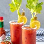 2 garnished non alcoholic bloody marys. Overlay text at top of image.