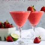 Two daiquiris garnished with fresh strawberries. Overlay text at top of image.