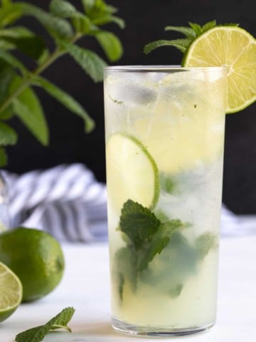 Front view of a non-alcoholic mojito garnished with lime and fresh mint.
