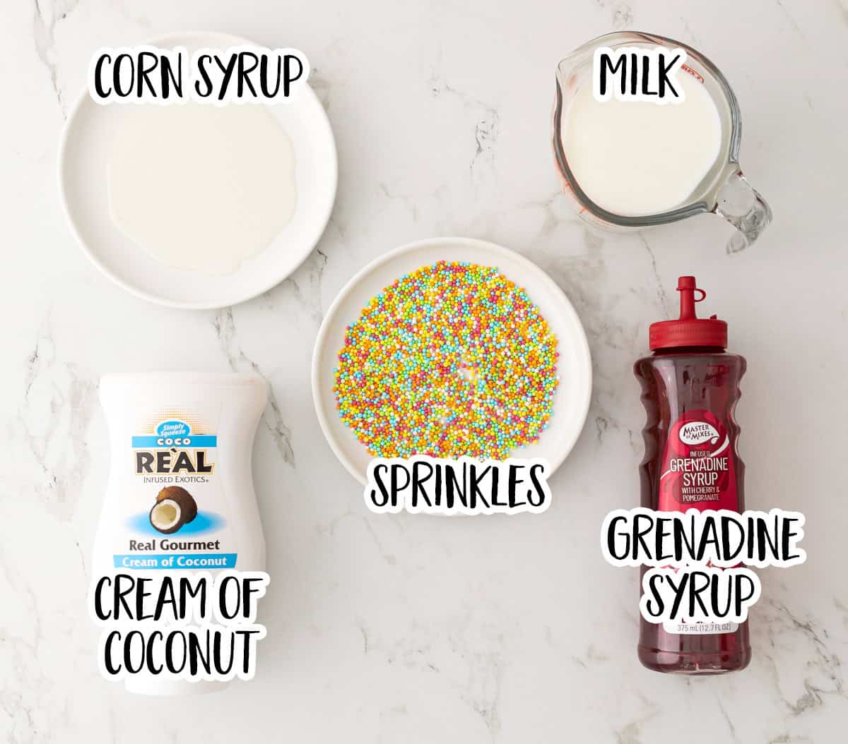 Overhead view ingredients needed for making a pink mocktail with overlay text for labeling the ingredients.